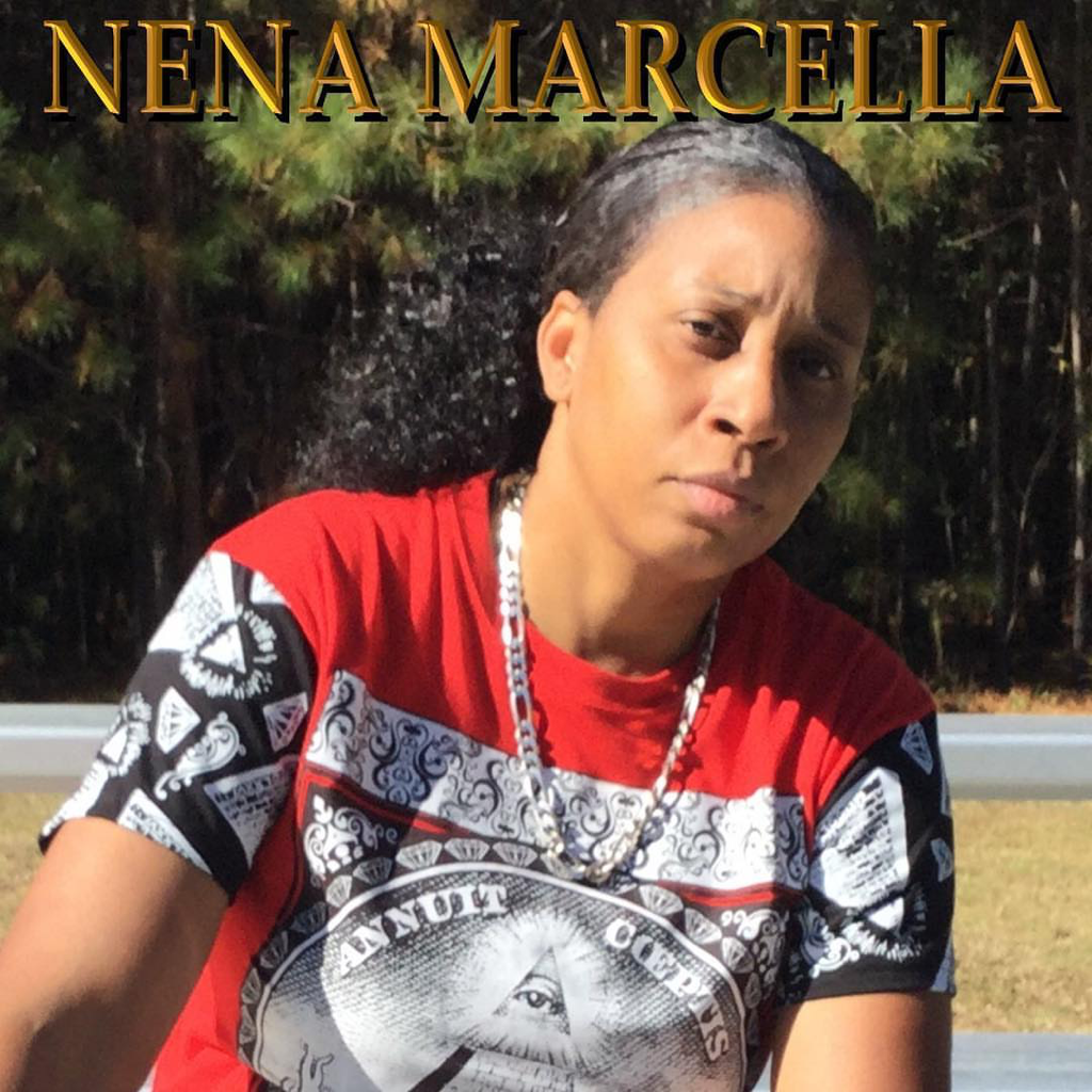 Nena Marcella wearing red shirt with all seeing eye on it